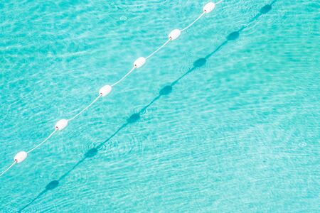 Pool water background with sun light reflect