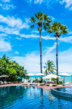 Umbrella and chair around beautiful luxury outdoor swimming pool in hotel resortの写真素材