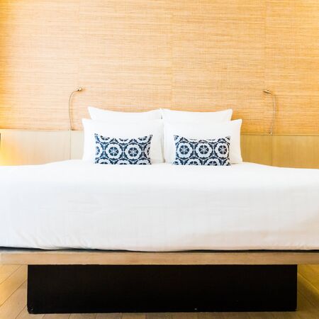 Beautiful white pillow on bed decoration in bedroom interior