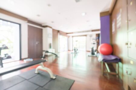 Abstract blur fitness and gym room interior with sport equipment for background