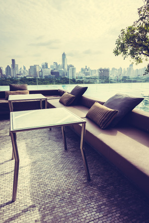 Umbrella and chair around Outdoor swimming pool with city view - Vintage Filterのeditorial素材
