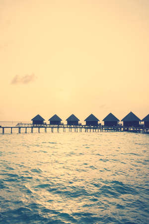 Beautiful tropical Sunset over maldives island with water bungalow in hotel resort - Vintage Filter and Boost up color Processingのeditorial素材