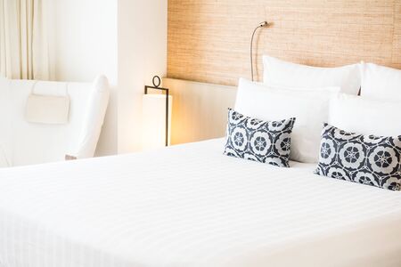 Beautiful white pillow on bed decoration in bedroom interior