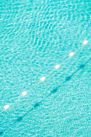 Pool water background with sun light reflectの写真素材