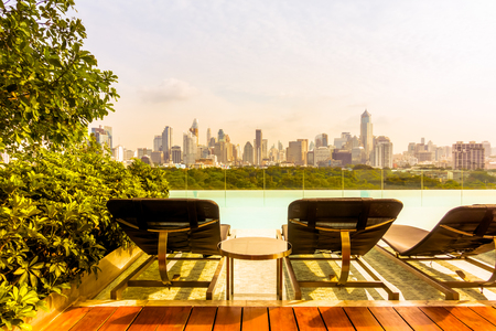 Chair around outdoor swimming pool with city view - Vintage Filterのeditorial素材