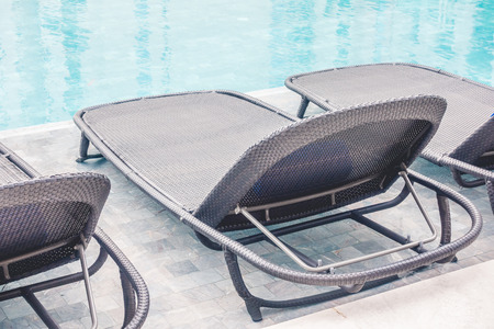 Chair decoration around swimming pool in hotel resort