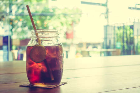 Iced colas glass on wooden table - Vintage Filterの写真素材