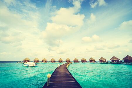 Beautiful tropical Maldives island with beach and sea for nature holiday vacation background concept - Vintage Filter and Boost up color Processingの写真素材