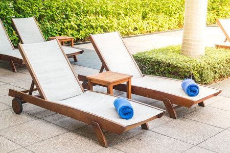 Umbrella and chair decoration around swimming pool  in hotel and resort - Sunflare effectの写真素材