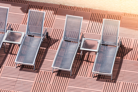 Umbrella and chair around outdoor swimming pool in beautiful luxury hotel and resort - Sunflare filterの写真素材