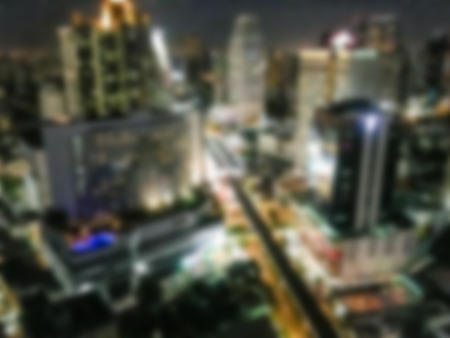 Abstract blur beautiful architecture around bangkok city skyline at night for backgroundの写真素材