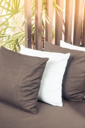 Beautiful pillow on sofa decoration with outdoor deck - Sunflare Effect