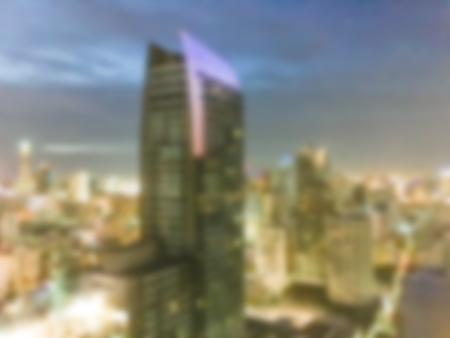 Abstract blur beautiful architecture around bangkok city skyline at night for background