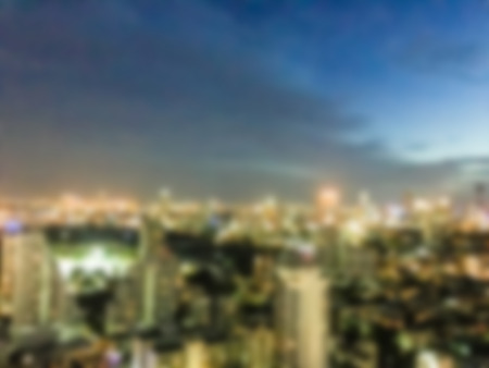 Abstract blur beautiful architecture around bangkok city skyline at night for background