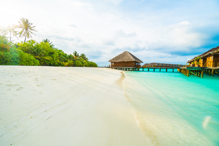 Beautiful tropical beach and sea with coconut palm tree on blue sky in Maldives island - Boost up color Processingの写真素材