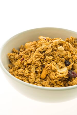 Granola in white bowl isolated on white background - Healthy food styleの写真素材