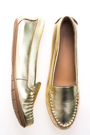 Beautiful luxury fashion woman shoes with golden color isolated on white backgroundの写真素材