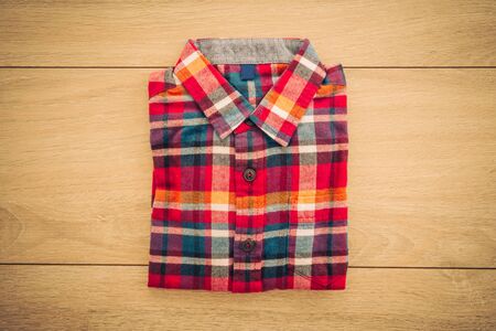 Beautiful men fashion shirt for clothing on wooden background - Vintage Filter Processingの写真素材