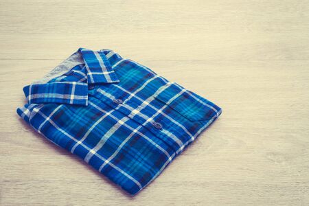 Beautiful men fashion shirt for clothing on wooden background - Vintage Filter Processingの写真素材