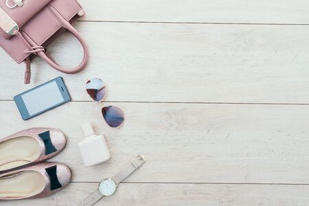 Beautiful casual woman fashion set with Pink Jacket Jeans Pants Handbag and Shoes on wood background with copy space - Vintage light Processingの写真素材