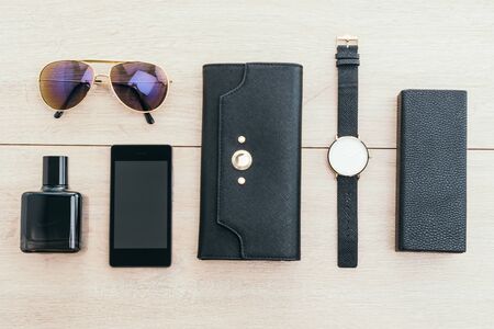 Beautiful accessory with wallet phone glasses watch perfume on wooden background - Vintage light...