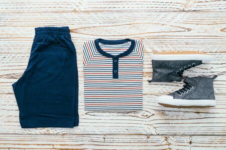 Men clothes set with T-shirt Jeans pants and shoes on wooden background - Vintage Filterの写真素材