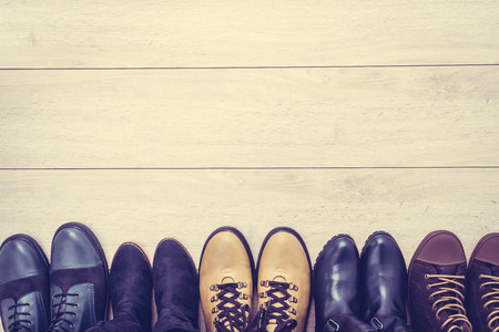 Leather boots and shoes on wooden background - Vintage Filterの写真素材
