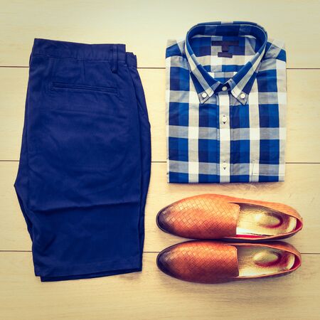 Top view of men clothing with Shirt Short Pant and Leather shoes on wood background - Vintage Filterの写真素材