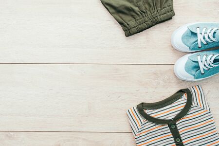 T-shirt with pants and shoes on wooden background - Vintage Filterの写真素材