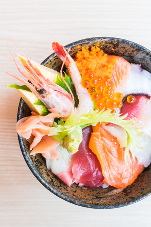 Japanese rice bowl with sashimi seafood on top - Selective focus pointの写真素材