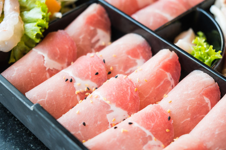 Raw pork meat in black plate - Selective focus pointの写真素材