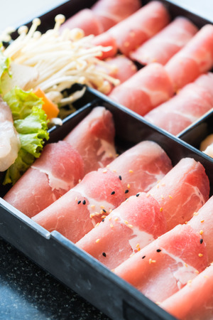 Raw pork meat in black plate - Selective focus pointの写真素材