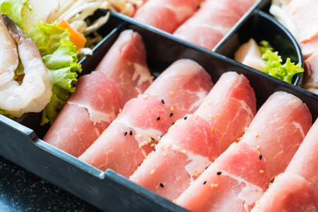 Raw pork meat in black plate - Selective focus pointの写真素材