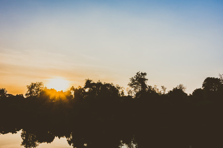 Beautiful silhouette landscape of river and sunset - Vintage Filter
