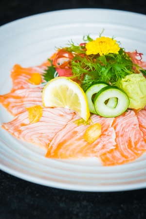 Raw fresh Carpaccio salmon in white plate - Japanese food styleの写真素材