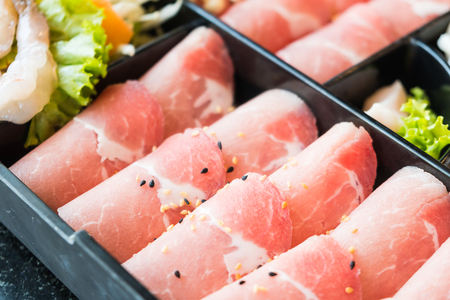 Raw pork meat in black plate - Selective focus pointの写真素材