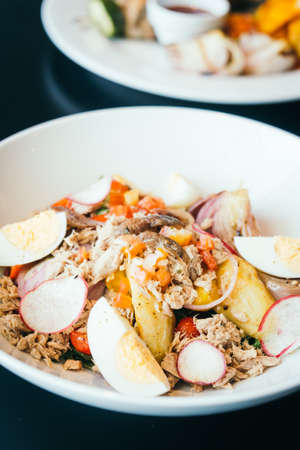 Tuna salad with egg in white bowl - Healthy food styleの写真素材