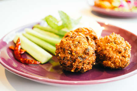 Spicy minced pork ball salad in plate - Thai food style , color filter Processingの写真素材