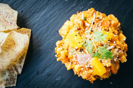 Raw fresh salmon meat tartare in black plate - Mexican food style , color filter Processing