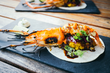 Taco with prawn or shrimp and sauce on black plate - Mexican food style , Color Filter Processingの写真素材