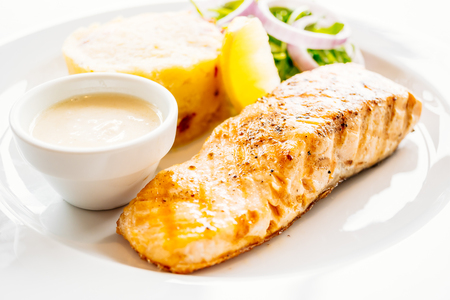 Salmon meat fillet steak in white plate - Healthy food styleの写真素材