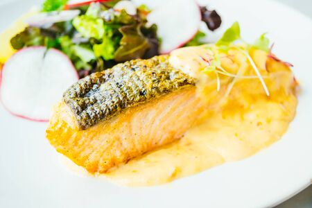 Grilled salmon fillet meat steak with vegetable in white plate - Color Filter Processingの写真素材