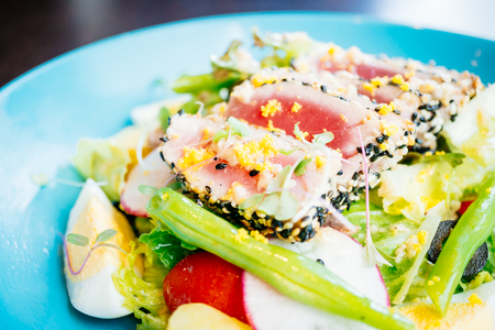 Raw and fresh tuna meat with sesame and fresh vegetable salad in plate - Healthy food style , Filter Processing colorの写真素材