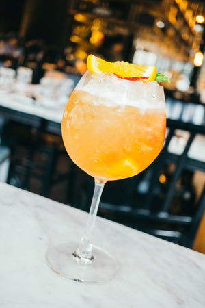 Ice cocktails drink glass with orange strawberry and mint on topの写真素材
