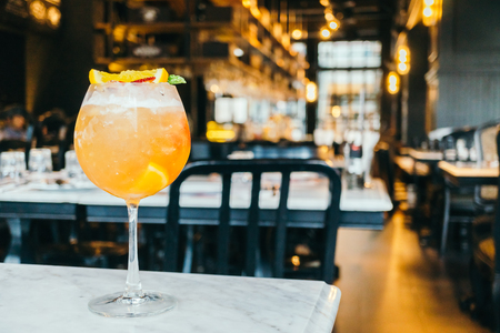 Ice cocktails drink glass with orange strawberry and mint on topの写真素材