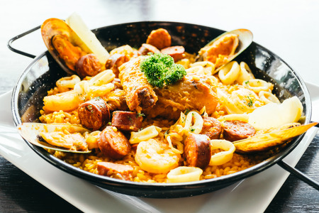 Spanich paella seafood in hot pan - Color filter Processingの写真素材