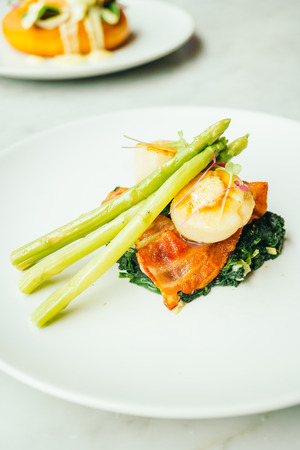 Grilled Scallops shell with bacon and asparagus vegetable in white plateの写真素材