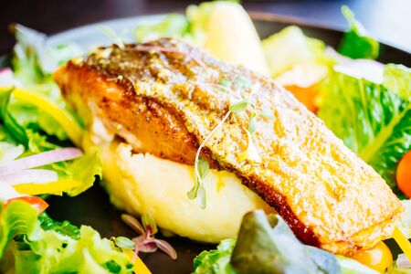 Salmon meat fillet steak with vegetable salad in plate - Healthy food style , Color filter...