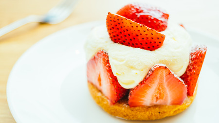 Sweet dessert with strawberry tart in white plateの写真素材