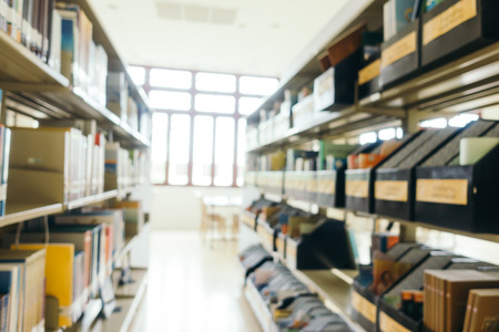 Abstract blur and defocused bookshelf in library interior for background